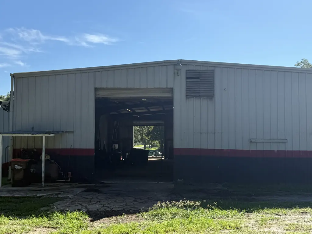 Main bay door at the North Florida Container dumpster repair shop in Ocala FL where roll-offs and compactors drop off