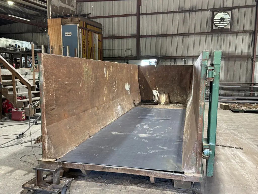 Looking down the length of a roll-off container after a full steel floor replacement at North Florida Container in Ocala